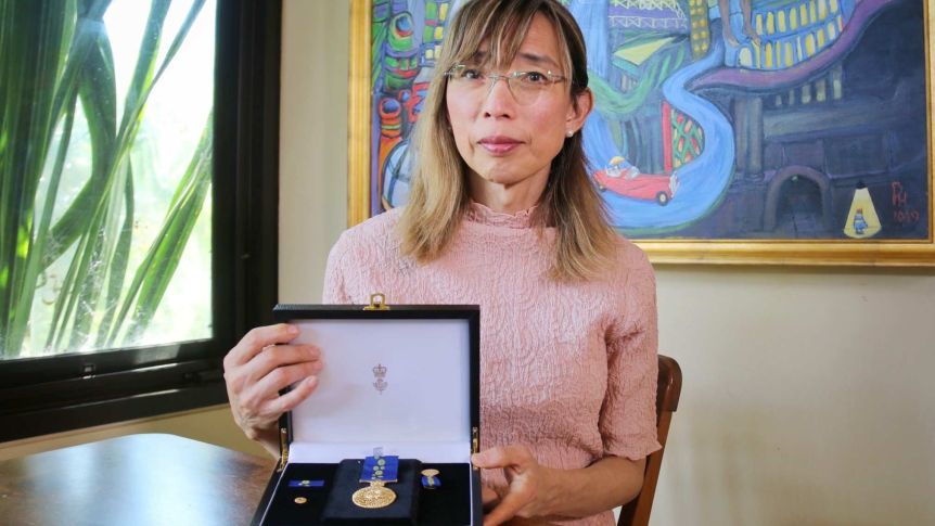 Woman holding medal