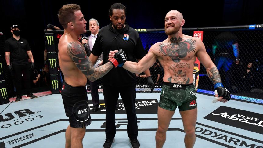 Dustin Poirier (left) shakes hands with Conor McGregor after winning their UFC 257 bout in Abu Dhabi.