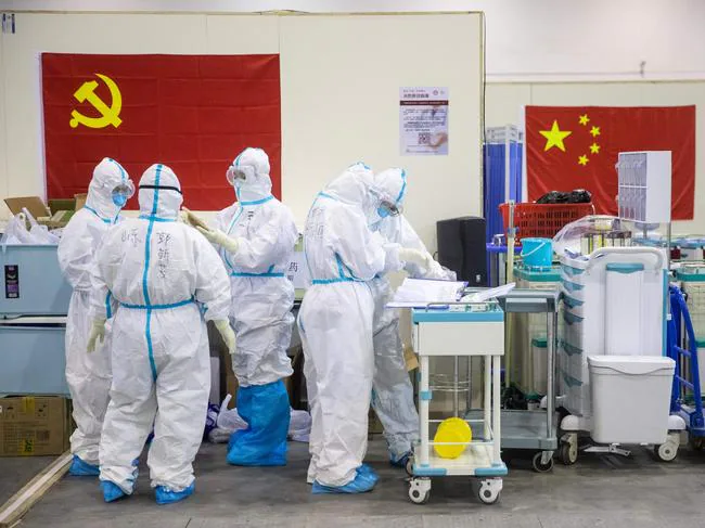 Medical staff members working at an exhibition centre converted into a hospital in Wuhan. Picture: AFP